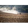 Tractor plowing a dry farm field