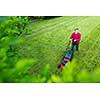 Senior man mowing his garden - shot from above - interesting angle view