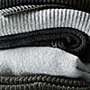 Pile of knitted winter clothes on background, sweaters, knitwear,