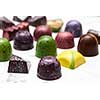 Luxury chocolate candies on a white marble background.