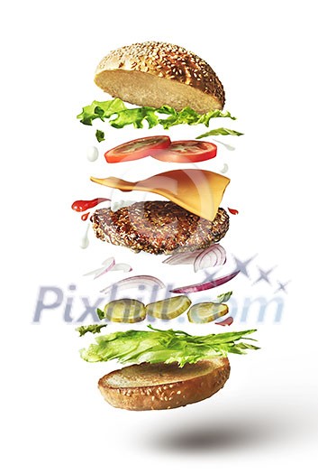 Delicious hamburger with flying ingredients on white background
