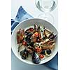 Steamed mussels in white wine sauce on the table