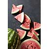 fresh watermelon and slices on a black table