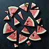 Background of fresh ripe watermelon slices on black