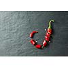Chopped red chilli pepper over black concrete background