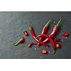 Sliced fresh red chillies isolated on a black concrete background