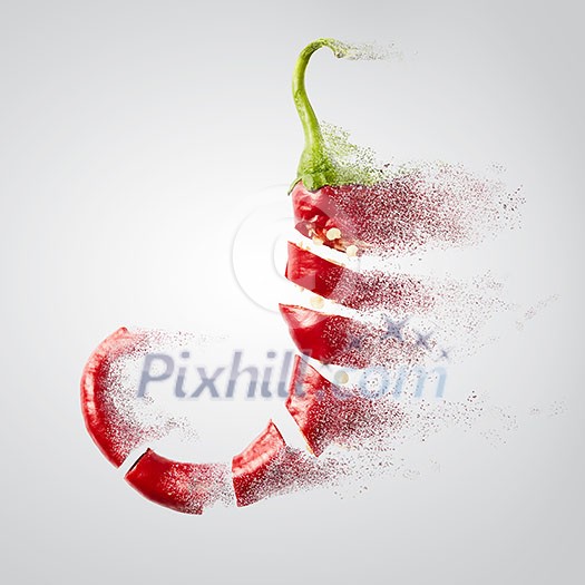 Fresh chopped red chilies into chili powder fly on white background Fresh chopped red chilies into chili powder fly on white background
