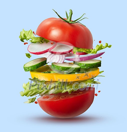 Flying ingredients of vegan burger isolated on blue . Concept idea for a healthy diet. Flying ingredients of vegan burger isolated on blue . Concept idea for a healthy diet.