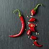 Fresh chopped red chili on a black concrete background