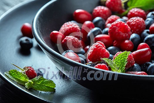 Fresh berries in the bowl. Raspberries and blue-berries, dessert, fresh berries close-up. healthy eating, food.