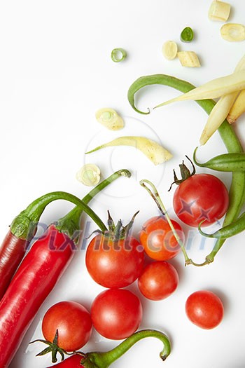 red pepper, yellow and green beans with cherry tomatoes. Salad on a white background.