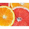 Mix fresh sliced orange, lemon and grapefruit on white background