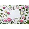 pattern flowers with empty white notebook on a white background, copy space for your text or design