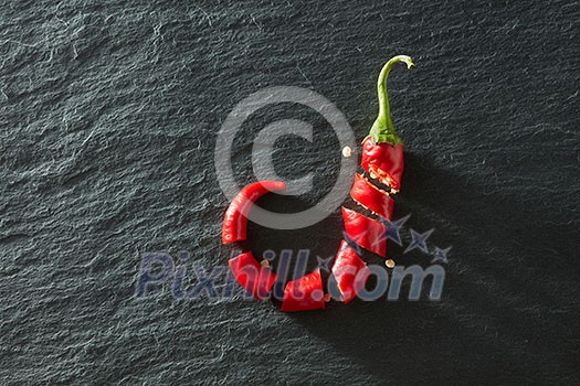 Fresh chopped red chili on a black concrete background Fresh chopped red chili on a black concrete background