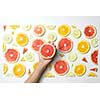 Mix fresh sliced orange, lemon and grapefruit on white background. Female hand putting slice grapefruit, Behind the scenes.