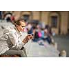 Gorgeous female tourist with a map discovering a foreign city (shallow DOF; color toned image)