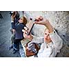 Young female tourist using her smart phone to capture photos from her summer vacation trip in an old italian city she is disovering (shallow DOF; color toned image)