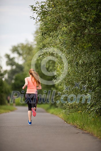 Young woman running outdoors on a lovely sunny winter/fall day