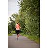 Young woman running outdoors on a lovely sunny winter/fall day