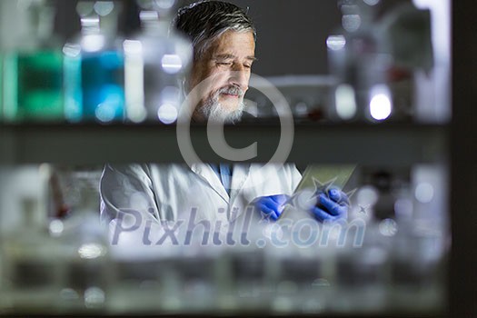 Senior male researcher carrying out scientific research in a lab (shallow DOF; color toned image) Senior male researcher carrying out scientific research in a lab (shallow DOF; color toned image)