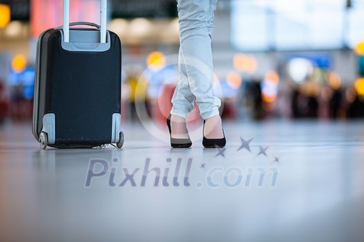 Pretty young female passenger at the airport (shallow DOF; color toned image)