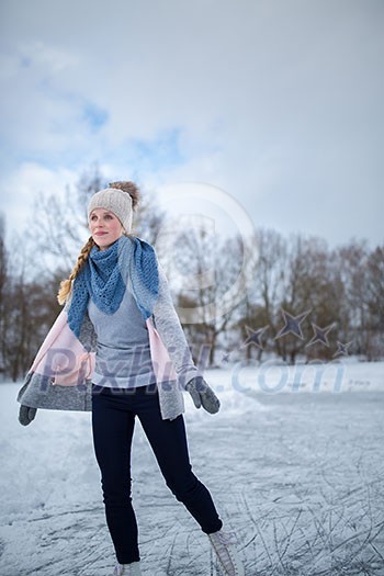 Young woman ice skating outdoors on a pond on a freezing winter day (color toned image; motion blurred image) Young woman ice skating outdoors on a pond on a freezing winter day (color toned image; motion blurred image)