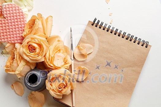 Notebook with roses and heart on white background Notebook with roses and heart on white background