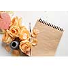 Notebook with roses and heart on white background