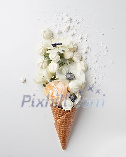 waffle cone with flowers bouquet and meringues on white background, flat lay, top view waffle cone with flowers bouquet and meringues on white background, flat lay, top view