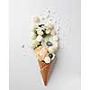 waffle cone with flowers bouquet and meringues on white background, flat lay, top view
