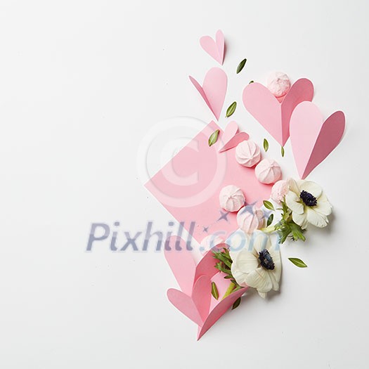 Beautiful hand made post card on white background with meringues, pink heart and flowers