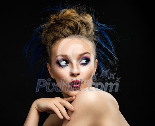 Woman with bright make-up and colourful hairstyle with expressive emotion. Touching her face.