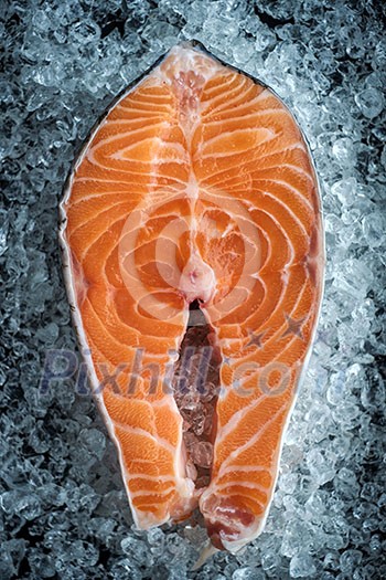 Closeup of Fresh Raw steak salmon on ice. top view. Closeup of Fresh Raw steak salmon on ice. top view.