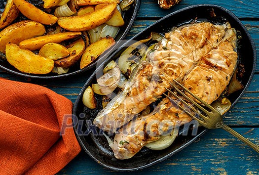 Salmon steak with vegetables on a grill pan.