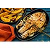 Salmon steak with vegetables on a grill pan.