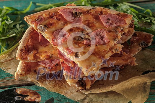 Slices of pizza on wooden table.