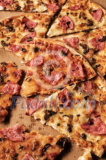 Slices of pizza on cardboard. Top view. Close-up. Slices of pizza on cardboard. Top view. Close-up.