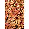 Slices of pizza on cardboard. Top view. Close-up.