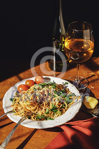 Spaghetti with cherry tomartoes served on a wooden table