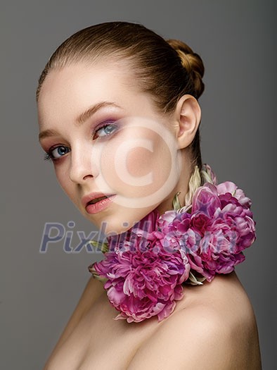Beautiful girl with colorful bright makeup, flowers. Beauty face.