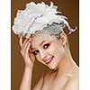 Beautiful girl in a wedding hat. Beige background.