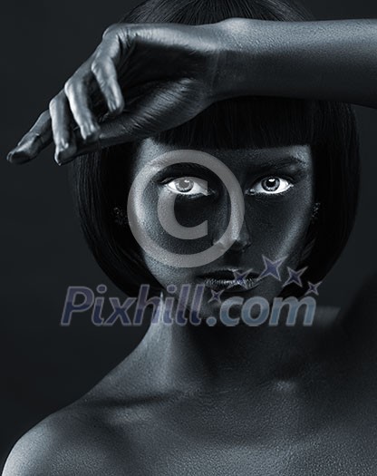 Portrait of a dark-skinned beautiful girl. Black Beauty face. Picture taken in the studio on a black background.