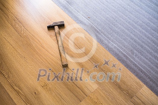 DIY, repair, building and home concept - close up of male hands lying parquet floor board/laminate flooring (shallow DOF; color toned image) DIY, repair, building and home concept - close up of male hands lying parquet floor board/laminate flooring (shallow DOF; color toned image)