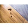 DIY, repair, building and home concept - close up of male hands lying parquet floor board/laminate flooring (shallow DOF; color toned image)