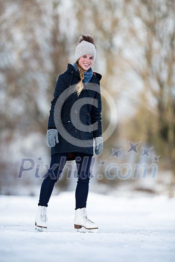 Young woman ice skating outdoors on a pond on a freezing winter day Young woman ice skating outdoors on a pond on a freezing winter day