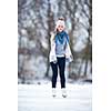 Young woman ice skating outdoors on a pond on a freezing winter day (color toned image; motion blurred image)