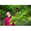 Senior man in his garden - shot from above - interesting angle view