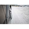 Car with winter tires on a slippery, snowy road - motion blur techinque used to convey movement, speed of the car