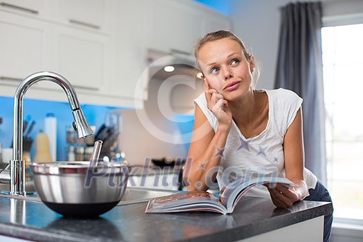 Pretty, young woman in her modern, clean and bright kitchen, thinking about what to cook for her family (color toned imagey; shallow DOF) Pretty, young woman in her modern, clean and bright kitchen, thinking about what to cook for her family (color toned imagey; shallow DOF)