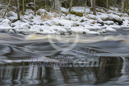 Flowing and snowy river scenery in january